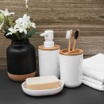 soap-toothbrush-cosmetic-bottle-towel-white-flower-vase-black-surface_23-2147927049